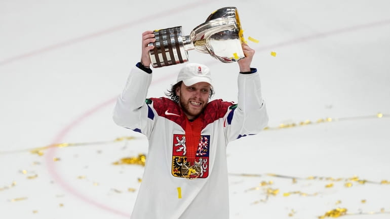 Czech Republic's David Pastrnak celebrates with their trophy after they...