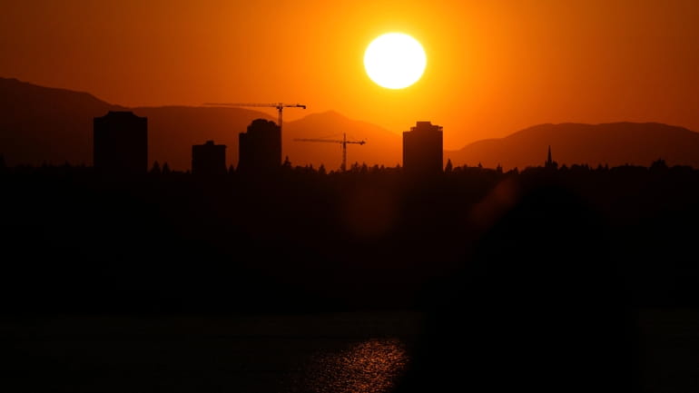 The sun sets over the University District in Seattle, May...