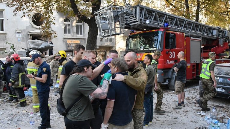 Medics give first aid to Yaroslav Bazylevych, who lost his...