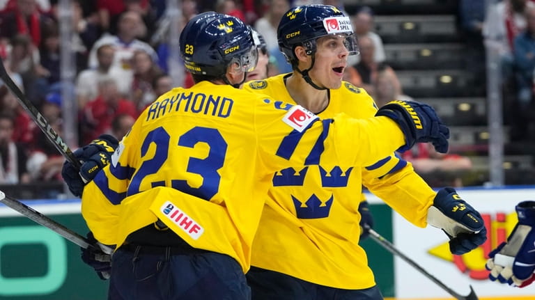Sweden's Joel Erikson Ek, right, celebrates with Sweden's Lucas Raymomd...