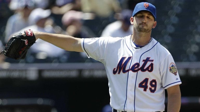 New York Mets starting pitcher Jonathan Niese reacts after giving...