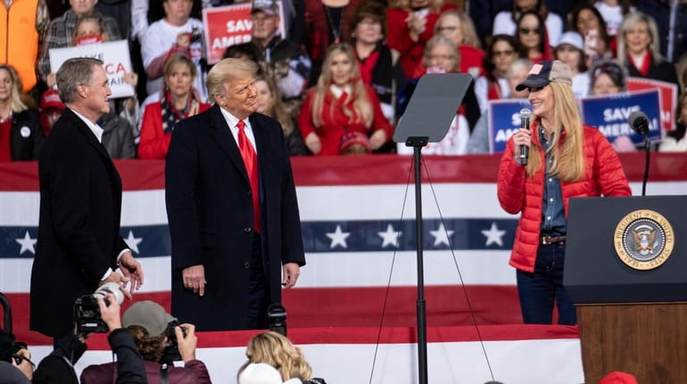 President Donald Trump shares the stage on Dec. 5 with...