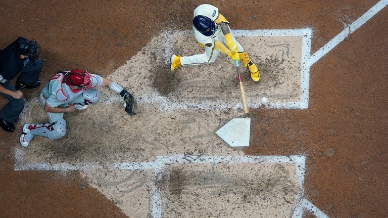 Milwaukee Brewers' Joey Ortiz hits an RBI triple during the...