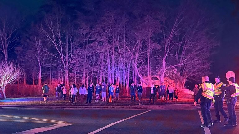 Neighborhood residents watch as first responders arrive at the scene...