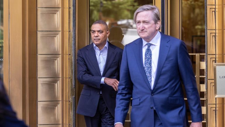 Jose Uribe, left, leaves the Manhattan federal court, after giving...