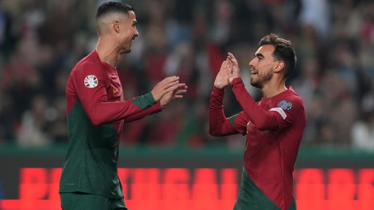 Portugal's Ricardo Horta, right, celebrates with Portugal's Cristiano Ronaldo after...