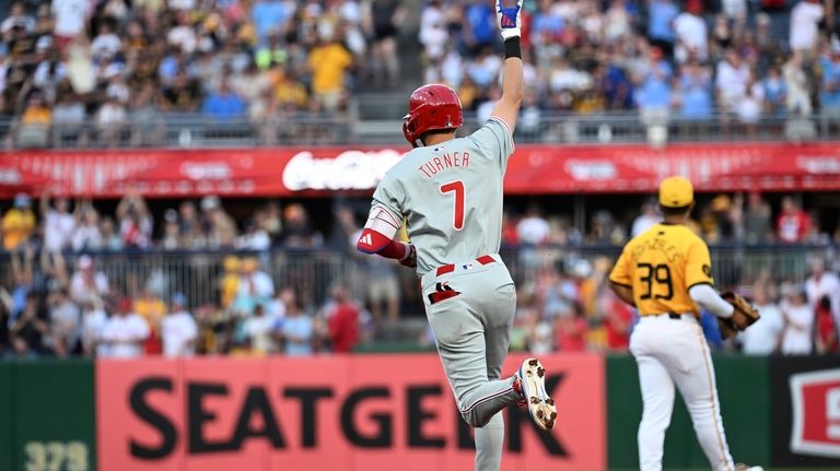 Philadelphia Phillies' Trea Turner (7) reacts as he rounds the...