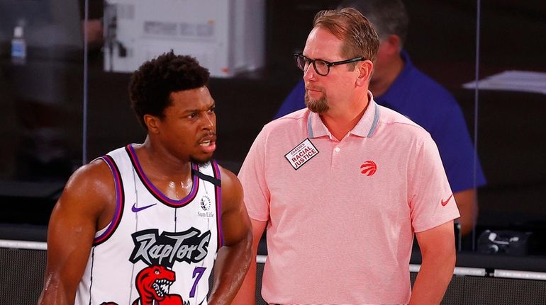 Toronto Raptors head coach Nick Nurse, right, talks with Kyle...