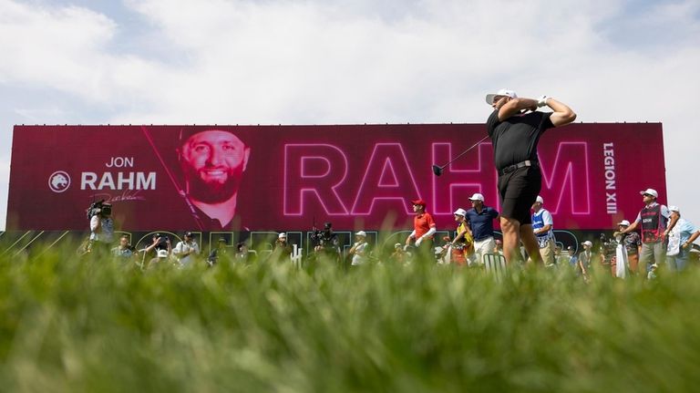 Captain Jon Rahm, front right, of Legion XIII, hits from...