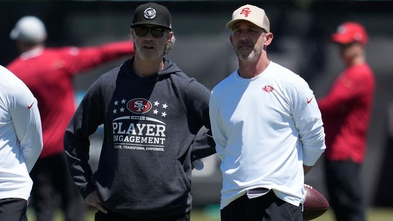 San Francisco 49ers defensive coordinator Nick Sorensen, left, and head...