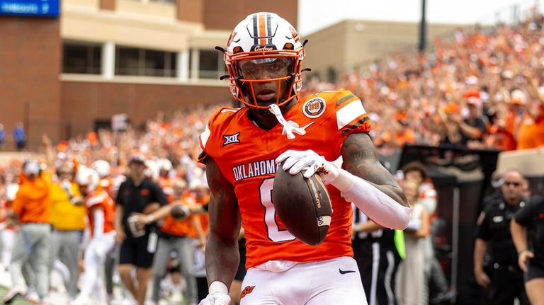 Oklahoma State running back Ollie Gordon II (0) celebrates in...