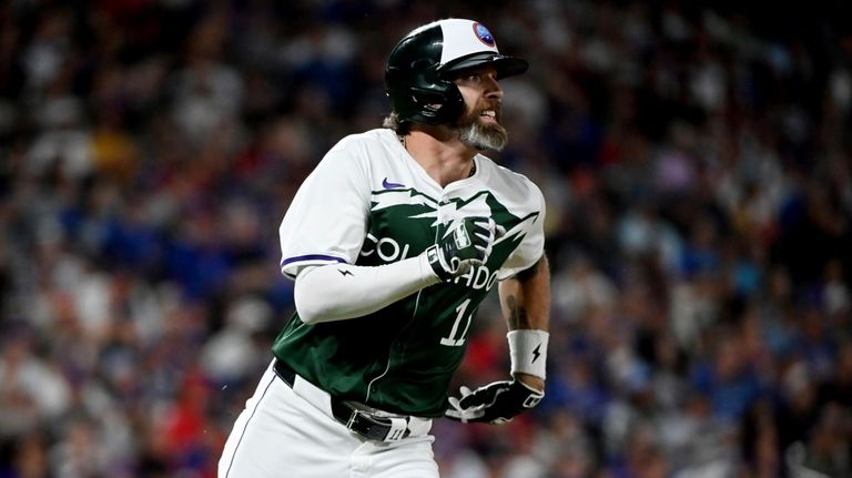 Colorado Rockies' Jake Cave runs to second base on a...