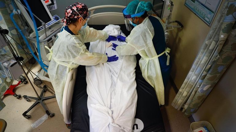 Nurse educator Katie DeMelis and nurse manager Nydia White tend...