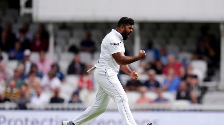 Sri Lanka's Lahiru Kumara celebrates taking the wicket of England's...