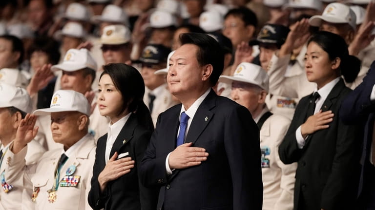 South Korean President Yoon Suk Yeol, center right, and his...
