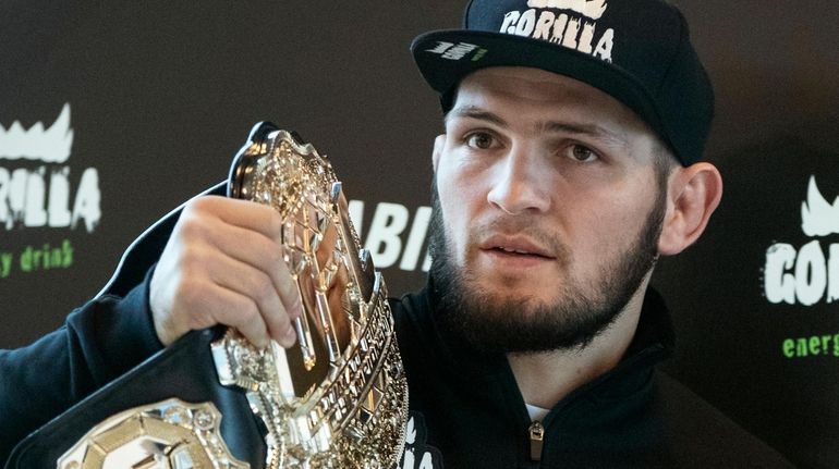 UFC lightweight champion Khabib Nurmagomedov holds the trophy belt during...