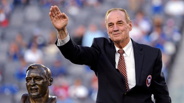 Former Giants linebacker Sam Huff waves to the fans as he...