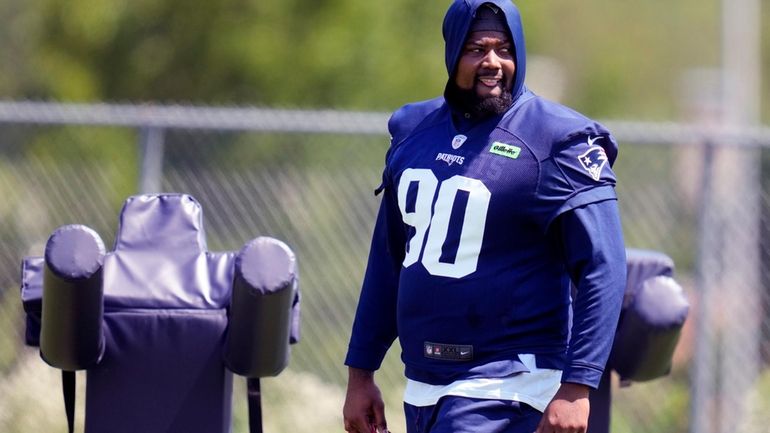 New England Patriots defensive tackle Christian Barmore (90) watches his...