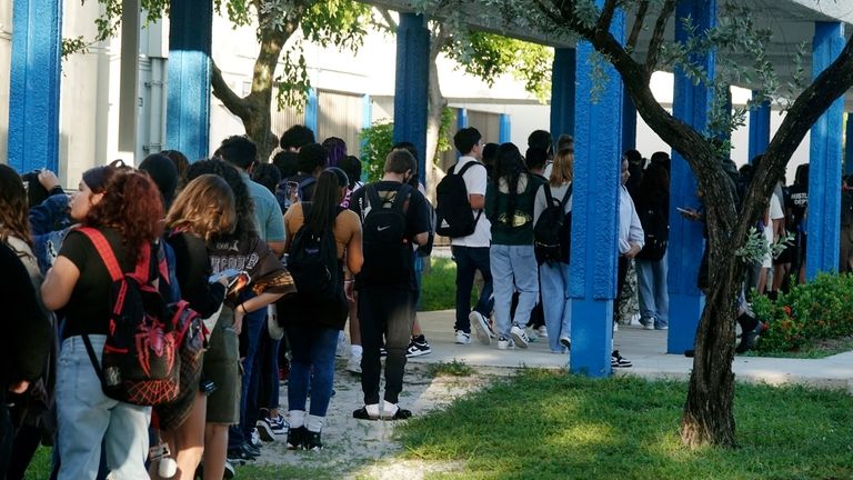 Students line up outside Hollywood Hills High School in Hollywood,...