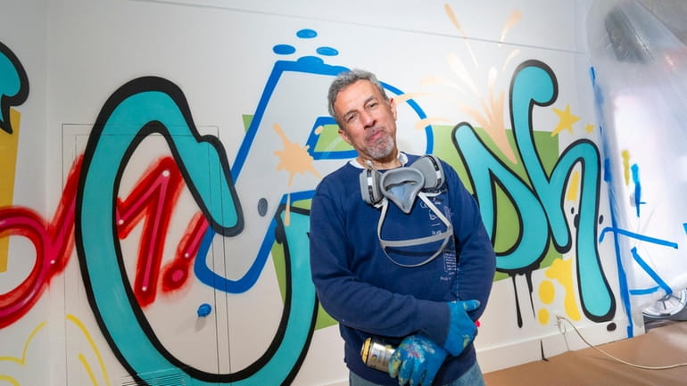 Street artist John "CRASH" Matos with his work-in-progress at the...