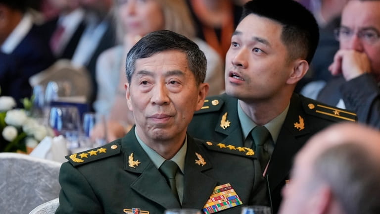 China Defense Minister Li Shangfu, left, listens to Australian Prime...