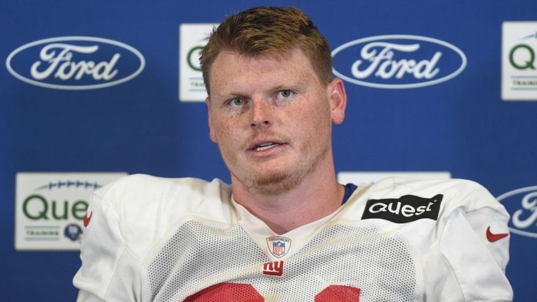 Giants center John Michael Schmitz Jr.  speaks with the media after...