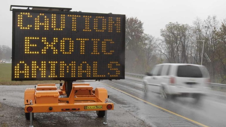 A sign warning motorists that exotic animals are on the...