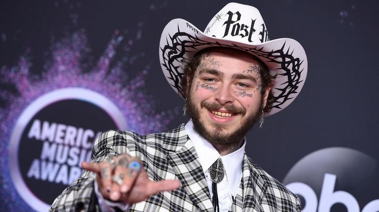 Post Malone arrives at the American Music Awards at the...