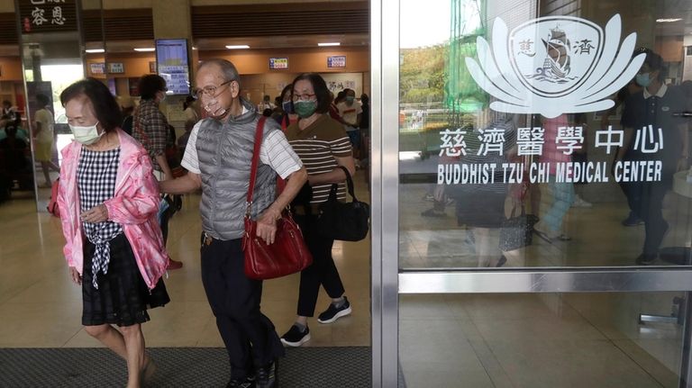 People walk out of Hualien Tzu Chi Hospital in Hualien,...