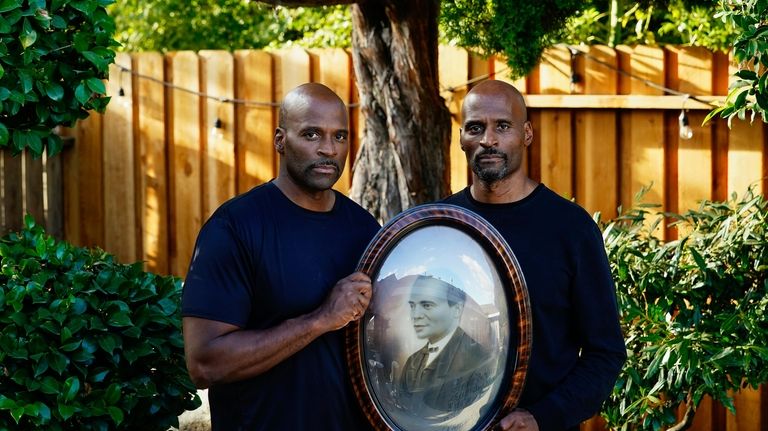 Matthew, left, and his twin brother Jonathan Burgess are photographed...