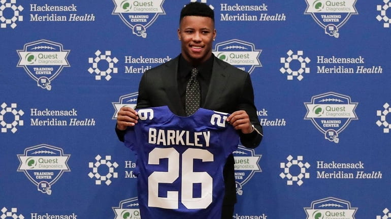 Giants running back Saquon Barkley poses for photos during a...