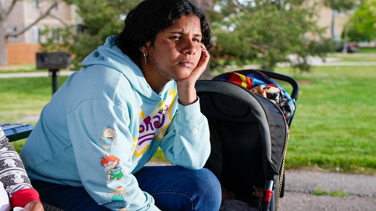 Ivanni Herrera looks on during an interview in a park...