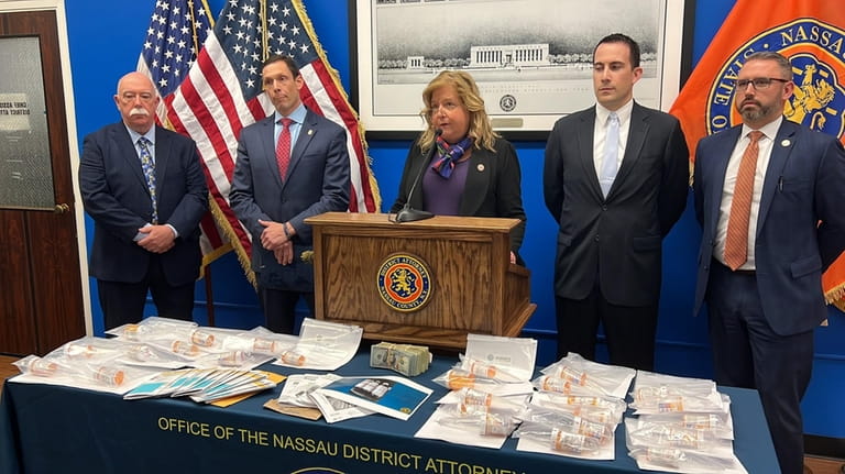 Nassau District Attorney Anne Donnelly, middle, announces the arrest of...