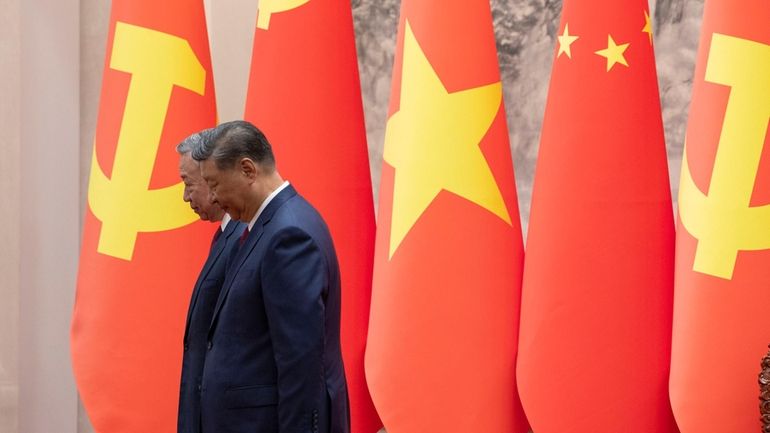 Chinese President Xi Jinping, right, and Vietnam's President To Lam...