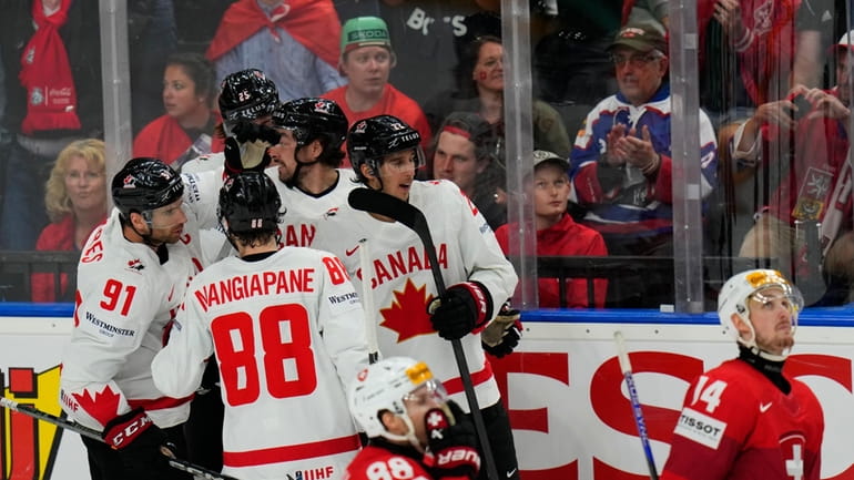 Canada's Dylan Cozens celebrates with teammates after scoring his sides...