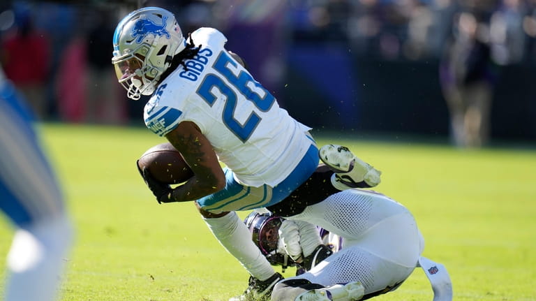 Detroit Lions running back Jahmyr Gibbs (26) is tackled by...