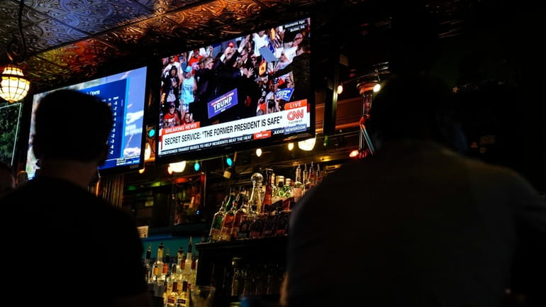 People sit in a local bar near the Fiserv Forum...