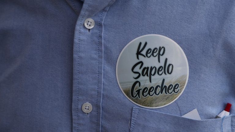 A supporter wears a sticker at the McIntosh County Commission...