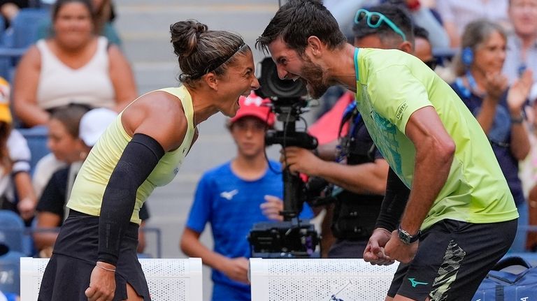 Sara Errani, of Italy, and Andrea Vavassori, of Italy, react...