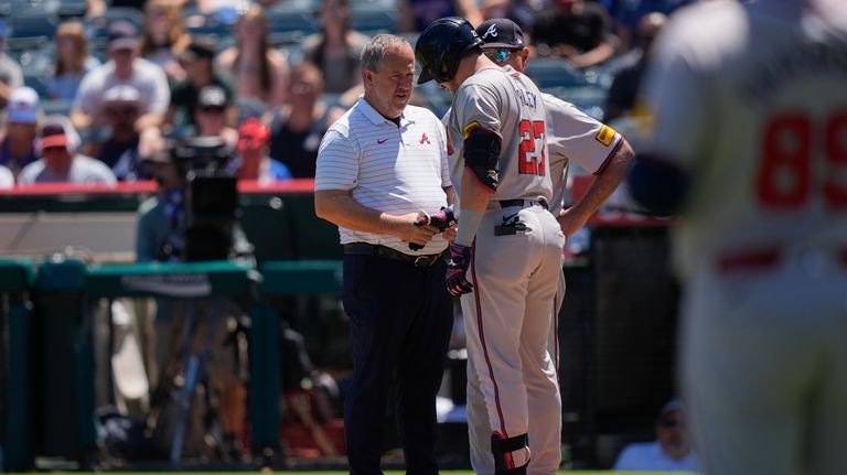 Atlanta Braves third baseman Austin Riley (27) is checked out...