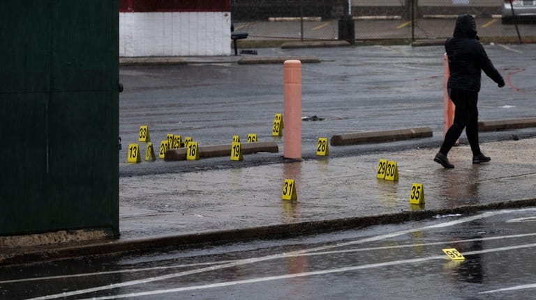 Evidence markers dot the ground following a shooting in Northeast...