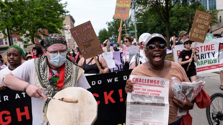 Protestors march near the Fiserv Forum during the first day...