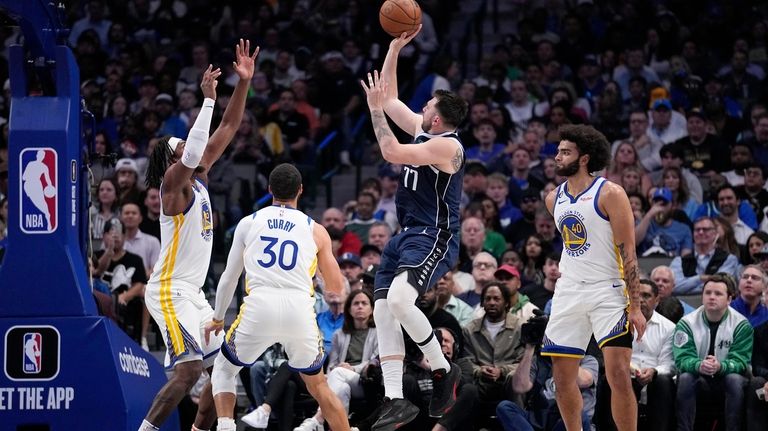 Dallas Mavericks guard Luka Doncic (77) takes a shot as...