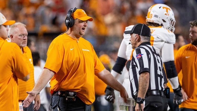 Tennessee head coach Josh Heupel, left, talks with head line...