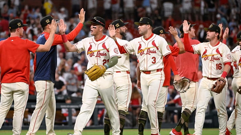 St. Louis Cardinals celebrate the team's 7-2 victory over the...