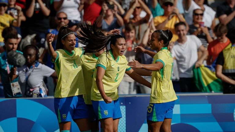 Brazil's Jheniffer celebrates scoring her team's first goal with teammates,...