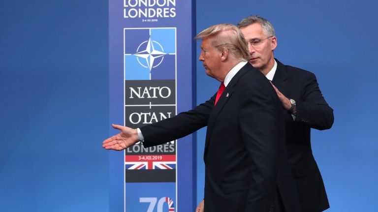 NATO Secretary General Jens Stoltenberg, right, directs U.S. President Donald...