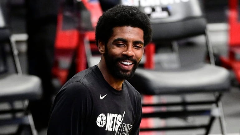 Kyrie Irving #11 of the Nets shares a laugh with...