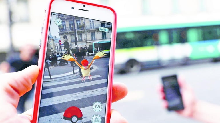 A pedestrian plays "Pokemon Go" on an iPhone.