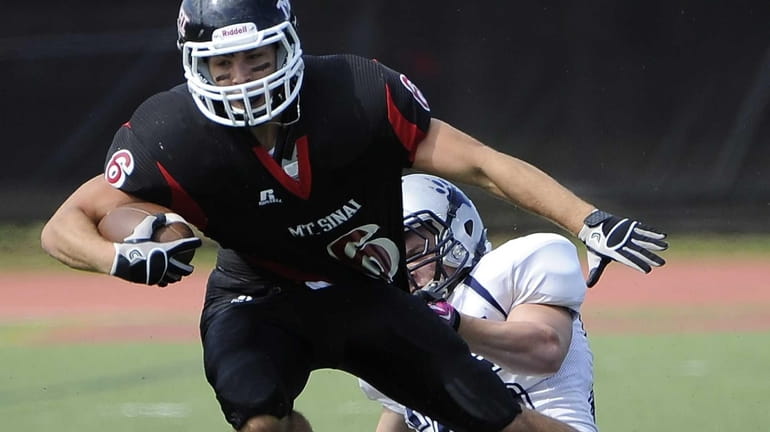 Mt. Sinai's Mike Donadio is tackled by Stony Brook's Don...